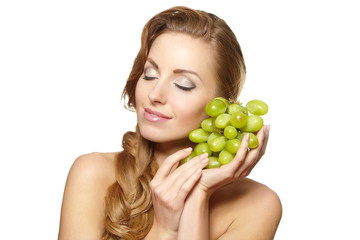 smiling beautiful woman holding a bunch of grape