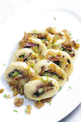roll from potato dough filled with spinach and bacon