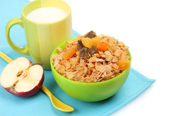 tasty cornflakes in green bowl, apple and glass of milk isolated