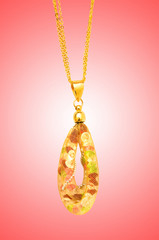 Golden jewellery against gradient background