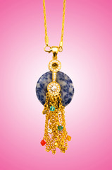 Golden jewellery against gradient background