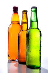 Beer in plastic bottle and Two glass bottles with beer, brown an