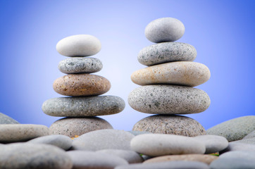 Obraz na płótnie Canvas Balanced pebbles with colour background