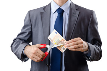 Man cutting money on white