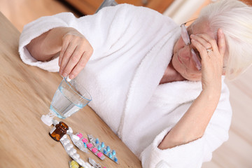 Obraz na płótnie Canvas Elderly woman with various medications
