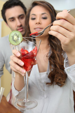 Couple Eating Strawberries From A Glass