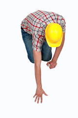 Tradesperson reaching to pick up a fallen object