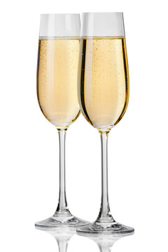 Champagne pouring in to a glass on a white background
