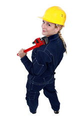 Tradeswoman holding a pipe wrench