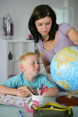 Woman giving her son a geography lesson