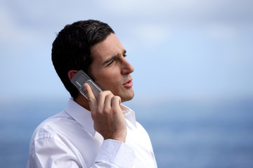 Businessman outdoors with a mobile phone
