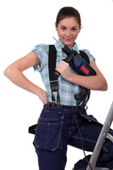 cute teenage apprentice holding electric drill