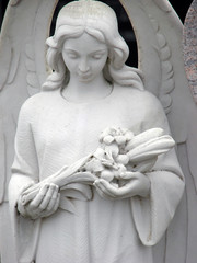 a white stone angel with flower