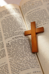 wooden cross on a old bible