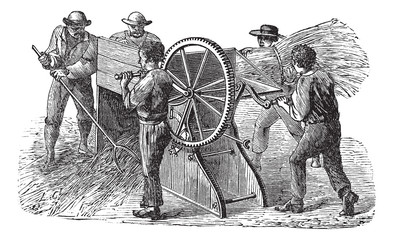 Five people using threshing machine also known as  thrashing mac