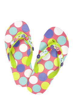 Pair of spoted flip flops on white, clipping path included