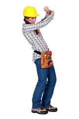 A female construction worker protecting her eyes.