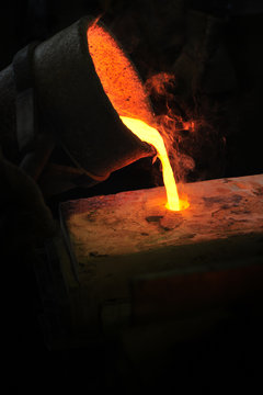 Foundry - molten metal poured from ladle into mould - lost wax