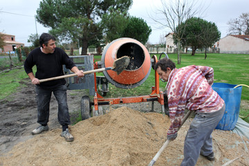 Labourers using a cement fixer