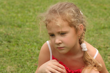 sad girl on grass background