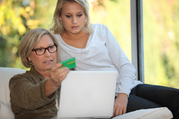 Elderly woman using a card online