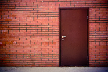 Red brick wall and the iron closed door