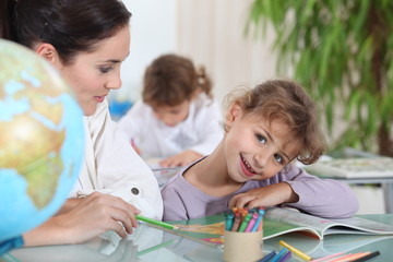 Teacher helping a pupil with her school work