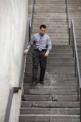 Hispanic Businessman - Walking Down Staircase