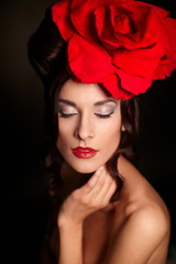 fashion woman with bright makeup lips with big red rose on head