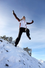 Woman jumping in the snow