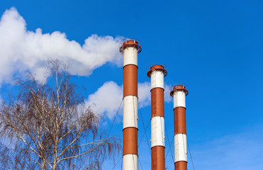 Lots of smoking chimneys other blue sky