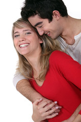 Fototapeta premium Young couple hugging in studio