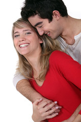 Young couple hugging in studio