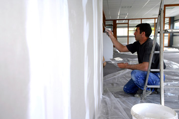 Fototapeta premium Man plastering a wall