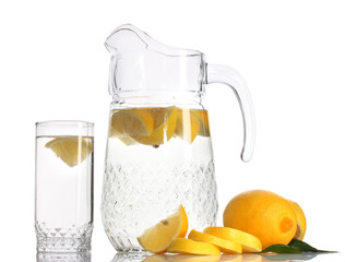 pitcher and glass of lemonade and lemon isolated on white