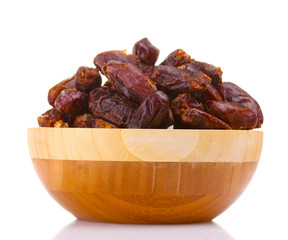 delicious dried dates in wooden bowl isolated on white
