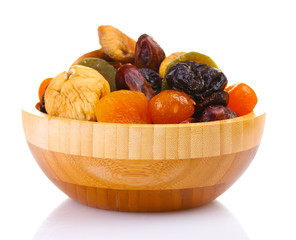 Dried fruits in wooden bowl isolated on white