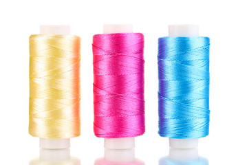 Three bobbin thread isolated on white