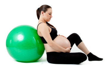 Fototapeta na wymiar Pregnant woman excercises with gymnastic ball. Beautiful pregnan