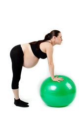 Fototapeta premium Pregnant woman excercises with gymnastic ball. Beautiful pregnan