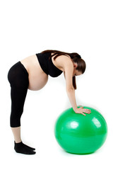 Pregnant woman excercises with gymnastic ball. Beautiful pregnan