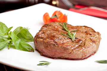 Grilled steak on a white plate