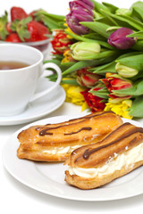 fresh cream puff with whipped cream and strawberry and cup of te