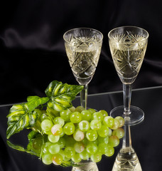 White wine in glass with grape