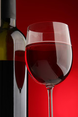 bottle with red wine and glass
