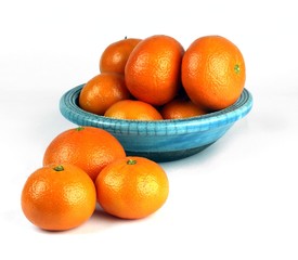 Oranges presented in a ceramic blue bowl