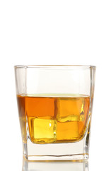 Glass of scotch whiskey and ice isolated on white