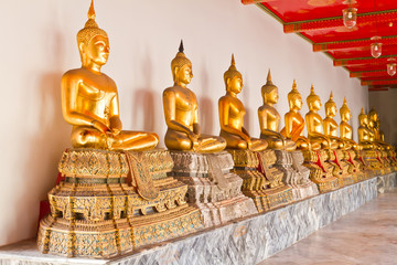 Golden sitting Buddha statue in row