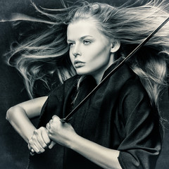 Closeup of beautiful girl with sword.