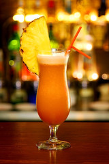 Orange cocktail standing on bar counter